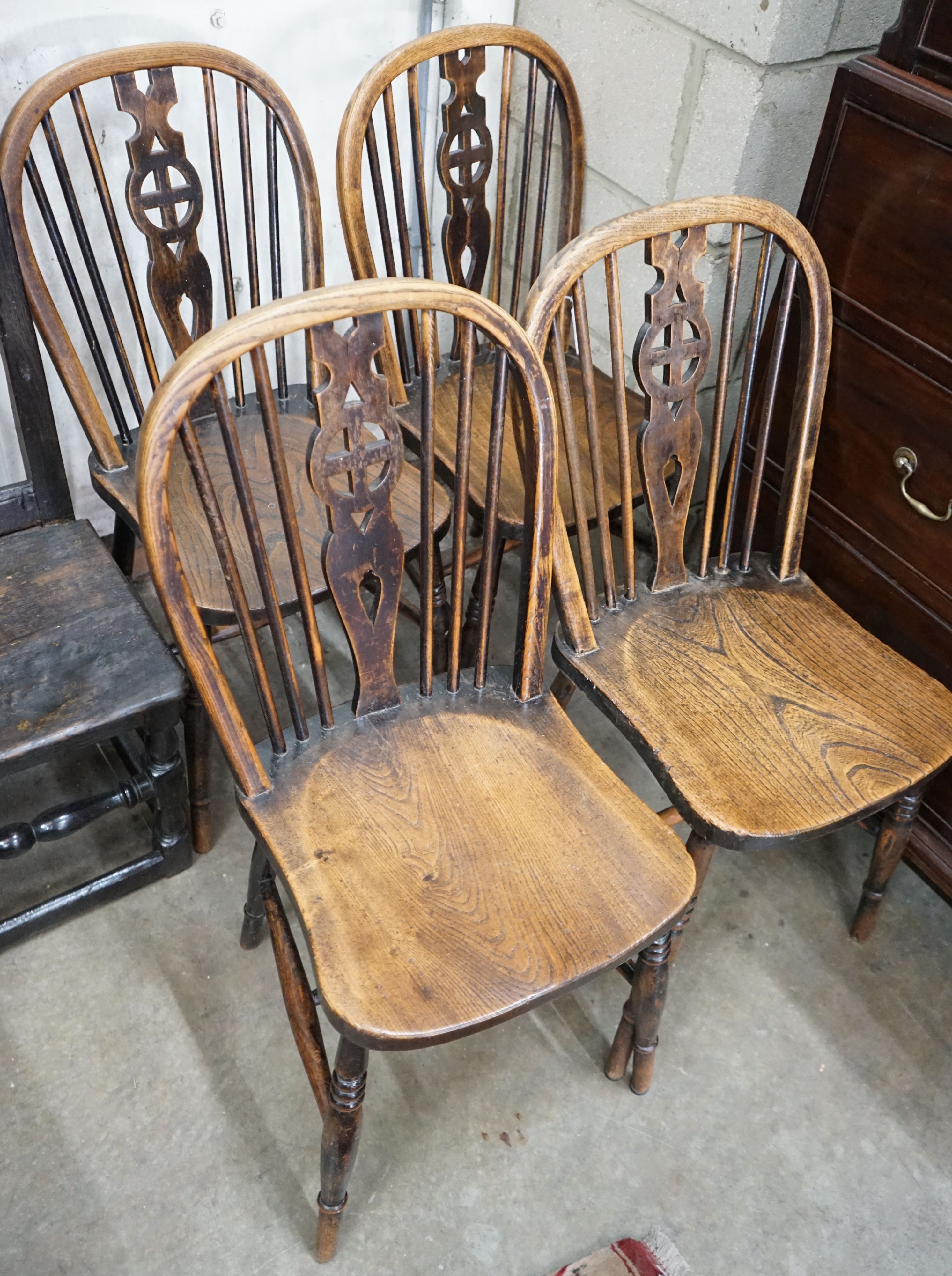 A set of four Victorian ash and elm Windsor wheelback dining chairs
